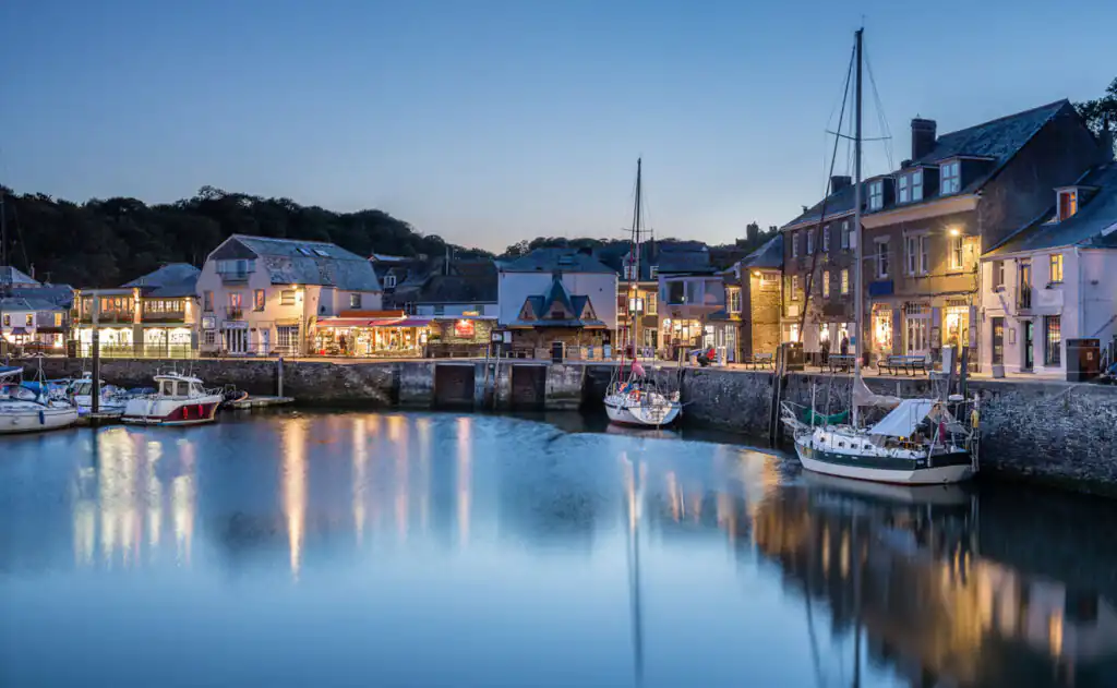 Dusk settles over Padstow Harbour, where boats are docked, marking the arrival of the New Year in Cornwall.