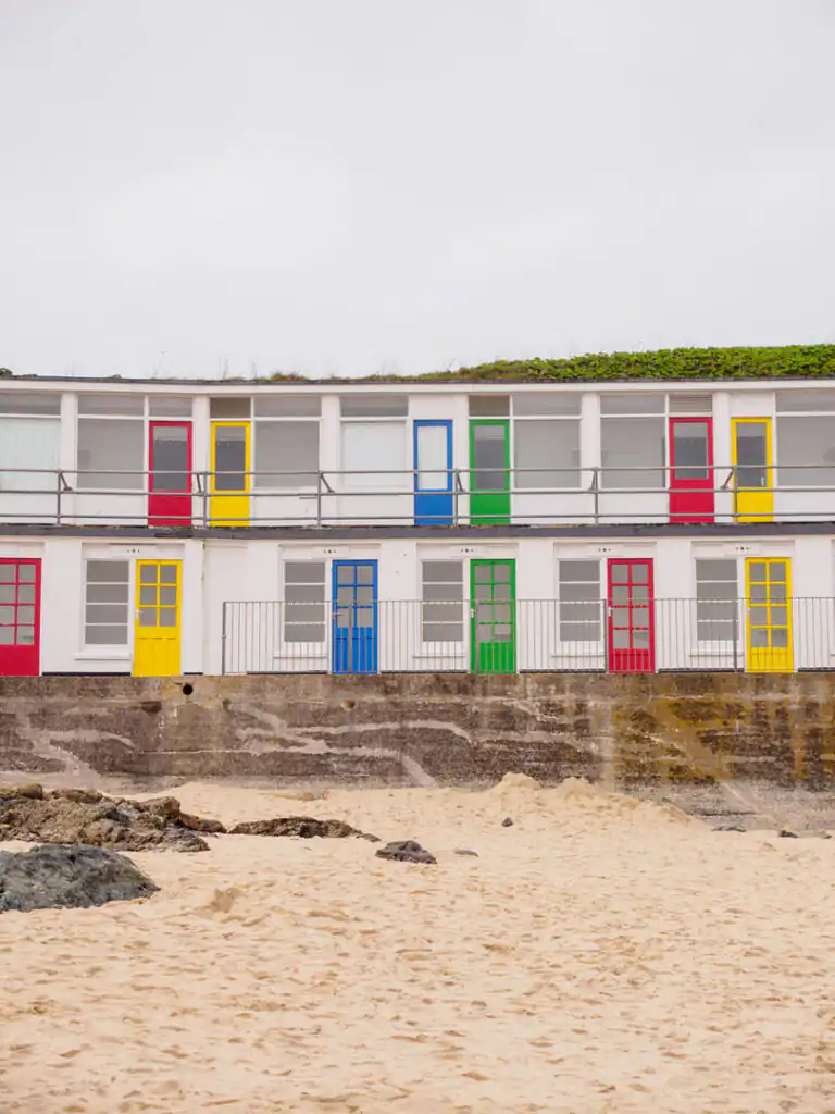 Colourful Beach Huts sitting on Porthgwidden Beach, perfect for a family day out.