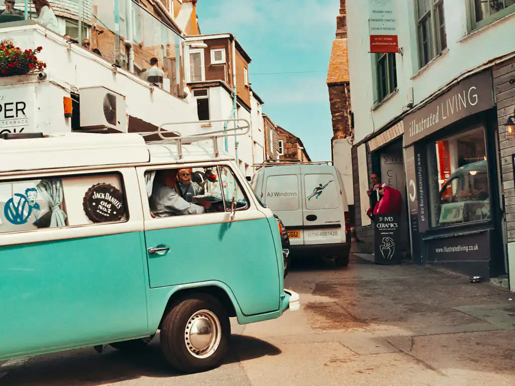 A blue VW Campervan navigating St Ives, finding its way to a St Ives cottage with parking.