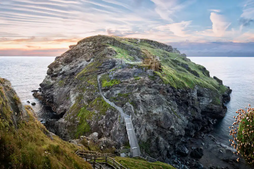 Peninsula of Tintagel Island and legendary castle ruins at sunset