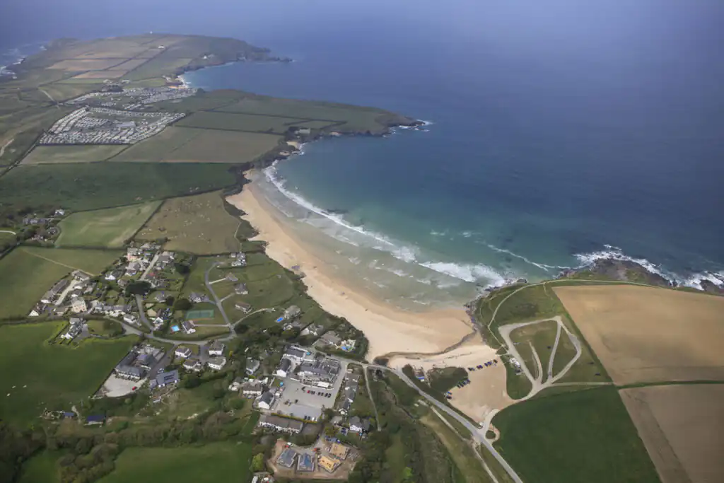 Aerial view of Harlyn Bay beach and the surrounding town, showcasing a scenic dog-friendly coastal landscape in Cornwall.