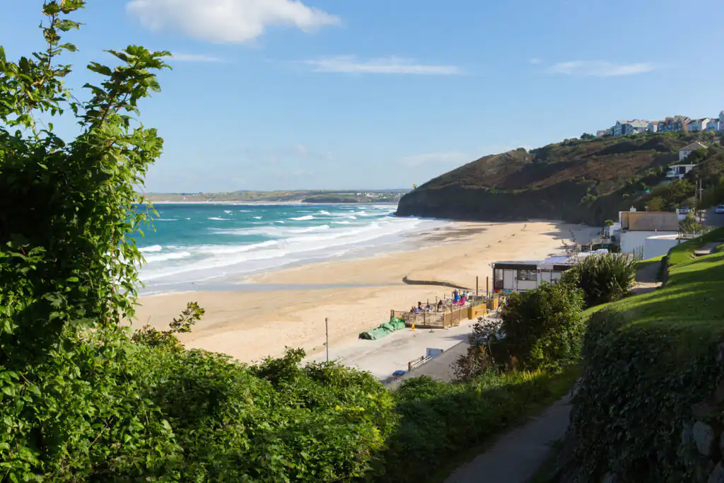 A sunny sandy beach at Carbis Bay Hotel, perfect for enjoying cream tea in St Ives.