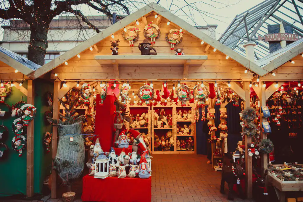 Festive Christmas market in Falmouth, Cornwall, featuring twinkling lights, stalls, and holiday decorations.
