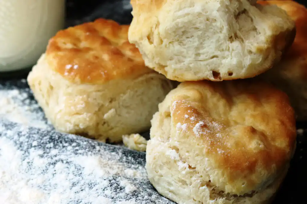 Freshly baked scones dusted with powdered sugar, a staple of a cream tea.