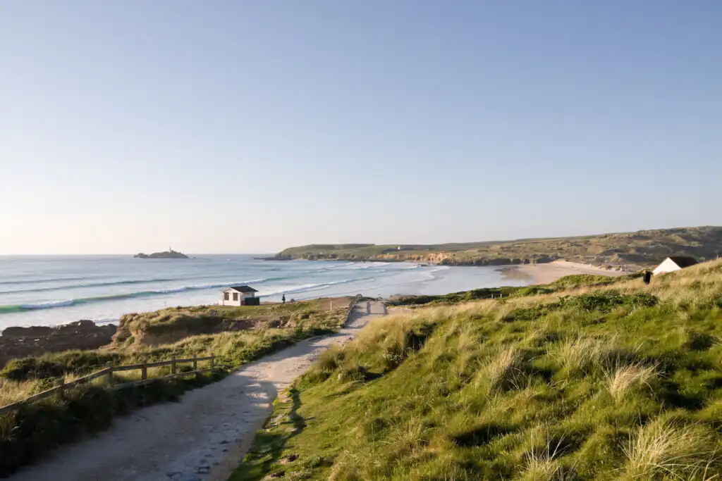 A tranquil path winding towards Gwithian Beach, Hayle, perfect for relaxation in West Cornwall.