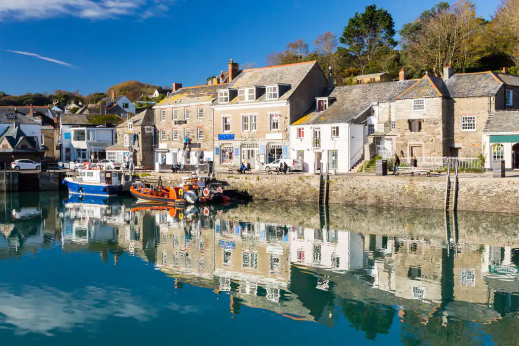 Clear blue sky dotted with fluffy white clouds, showcasing the beauty of Padstow, Cornwall.