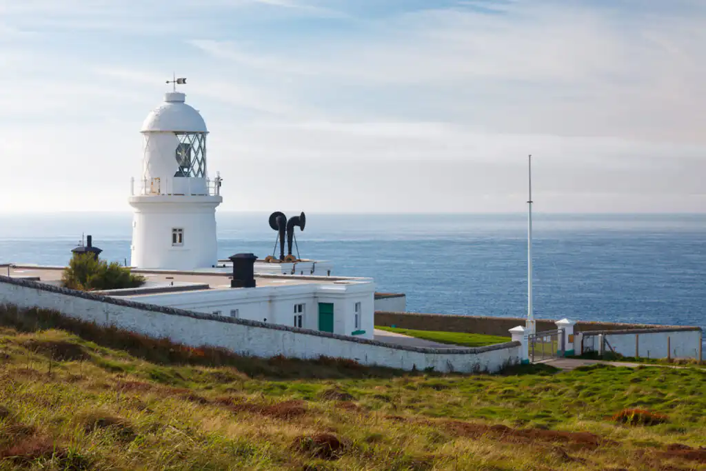 Pendeen Lighthouse stands tall on a hill, a picturesque romantic destination in Cornwall.