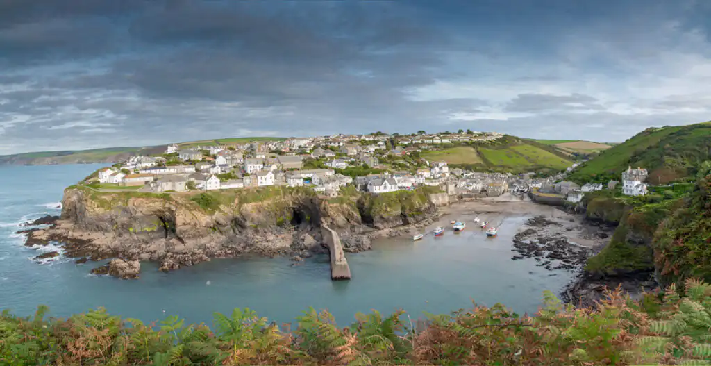 Charming Port Isaac, a small town on a hill with ocean views, exemplifying the allure of Cornwall's coastal villages.