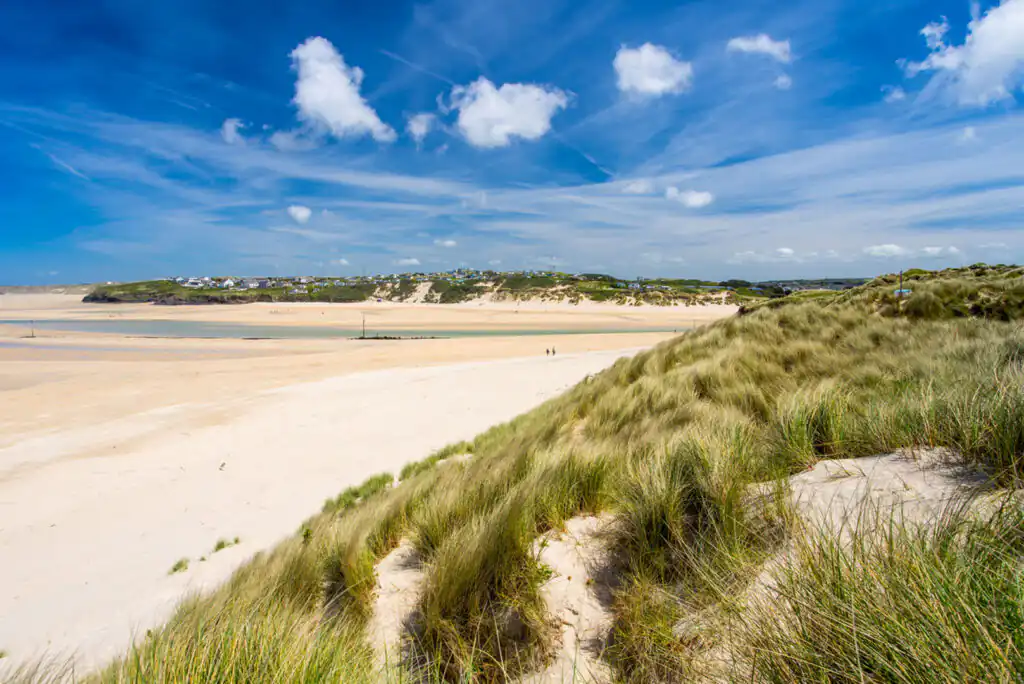 Clear blue sky filled with white clouds over Porthkidney Sands, Lelant, perfect for a tranquil day of rest and rejuvenation in West Cornwall.