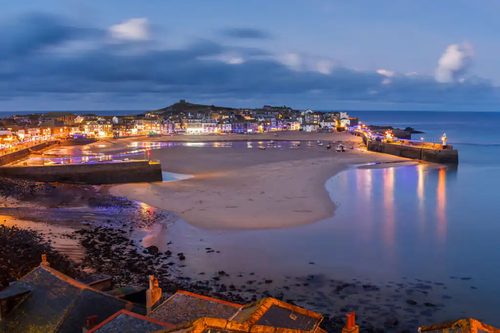 A beautiful beach in St Ives, Cornwall, with calm waters and golden sand, perfect for a romantic getaway.