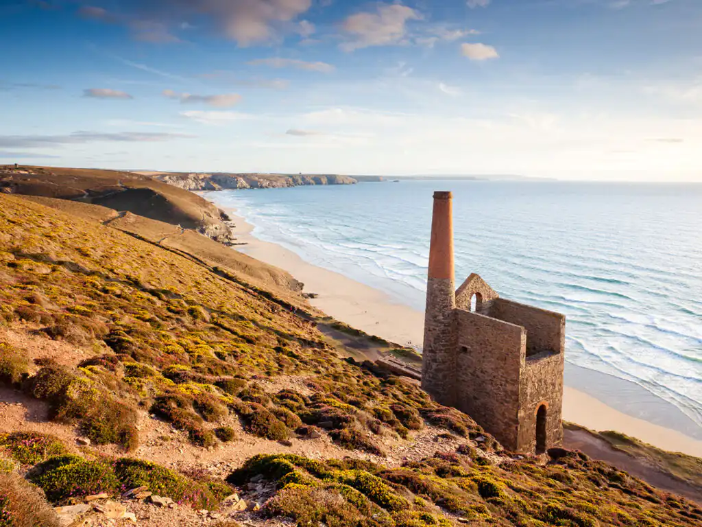 Scenic view of Towanroath Engine House on a hill overlooking a beach near St Agnes, Cornwall.