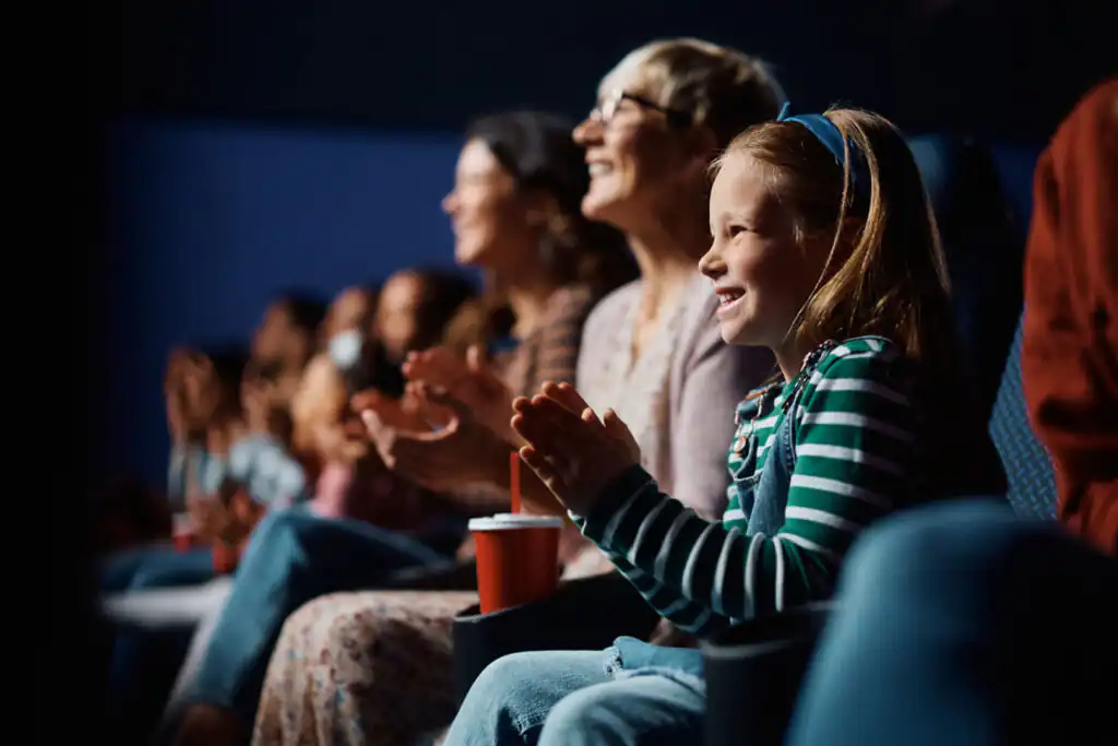 A family enjoying a movie together in a cinema during February Half Term in Cornwall.