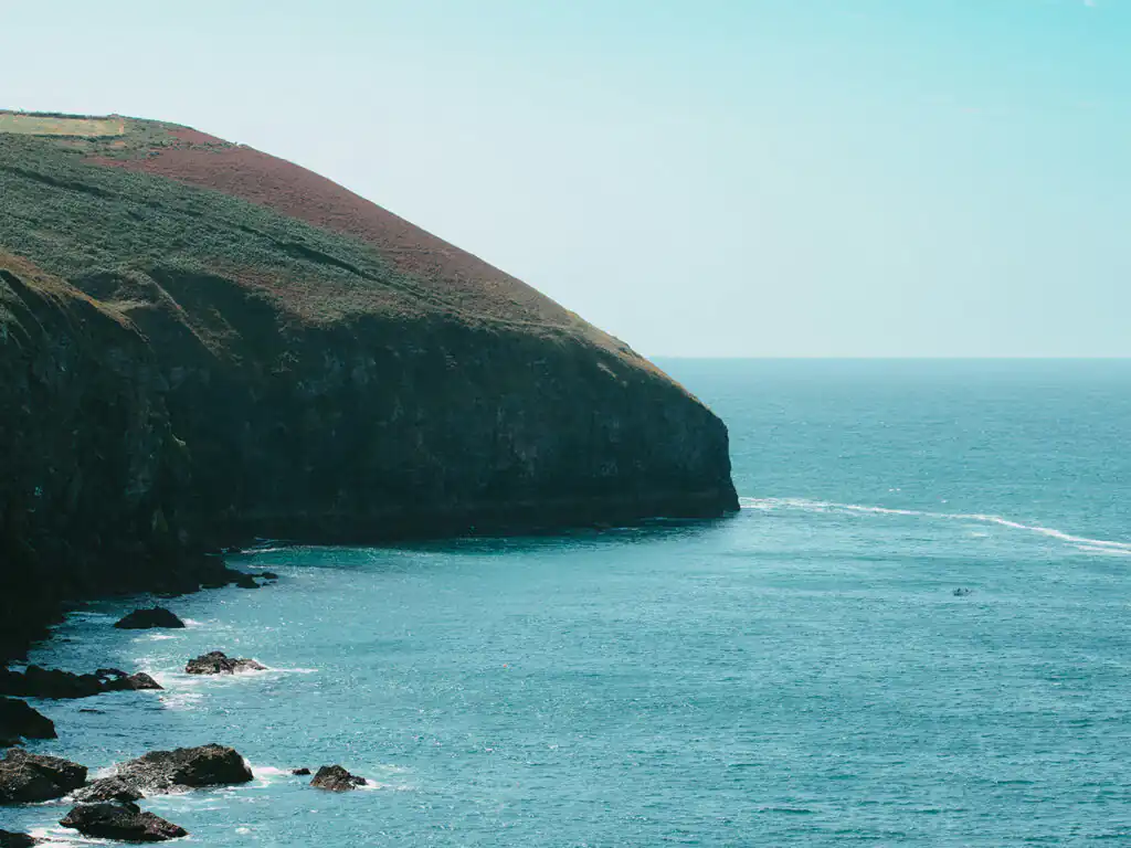Coast near St Agnes Cliffs, with the sparkling water of Cornwall in the background, a great place to visit on a weekend break in Cornwall.