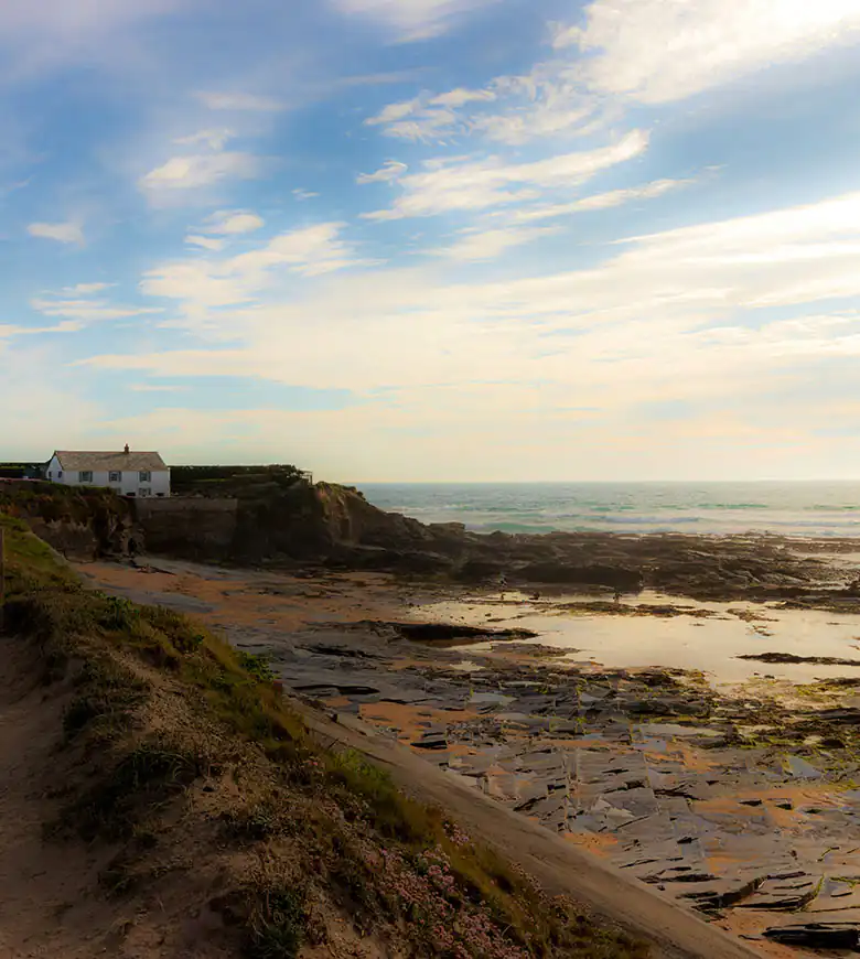 Dirt path by the Camel Estuary near Padstow, surrounded by lush greenery and coastline.