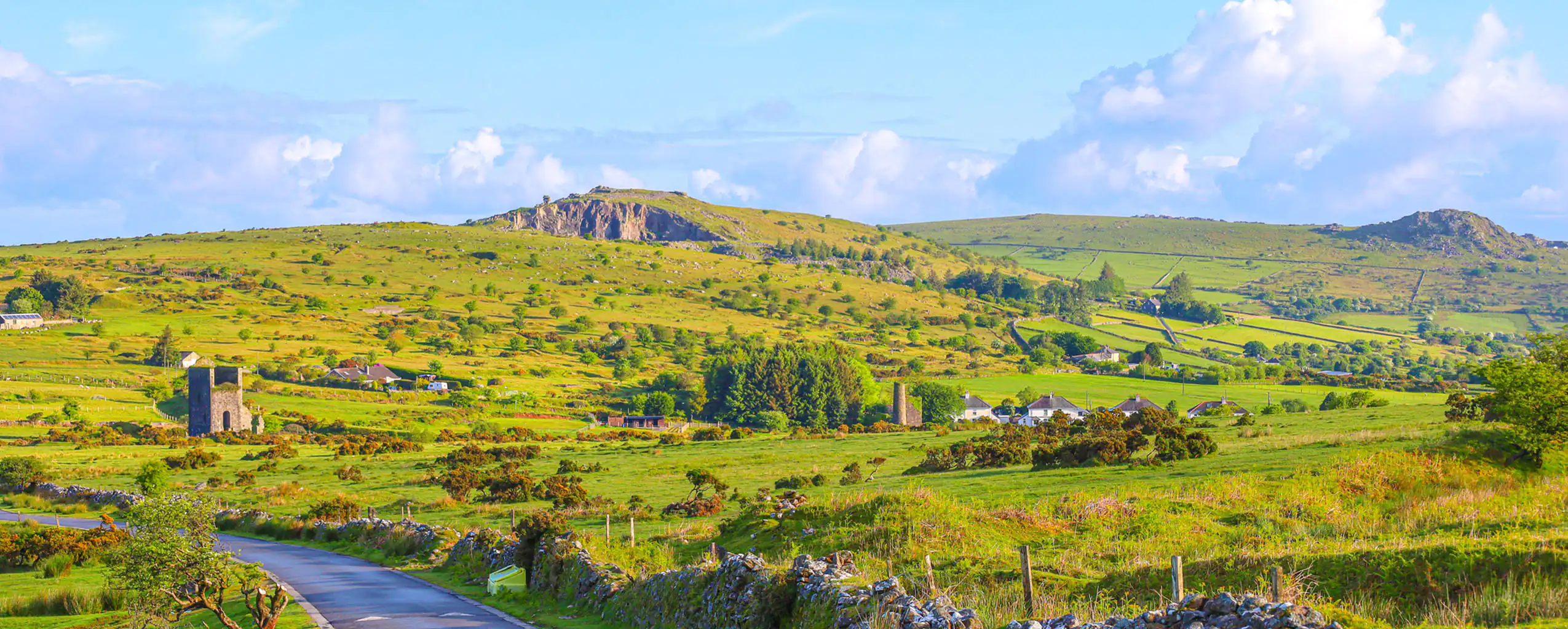 scenic rolling hills at Bodmin Moor, with a bright blue sky, ideal for a Cornish day out.