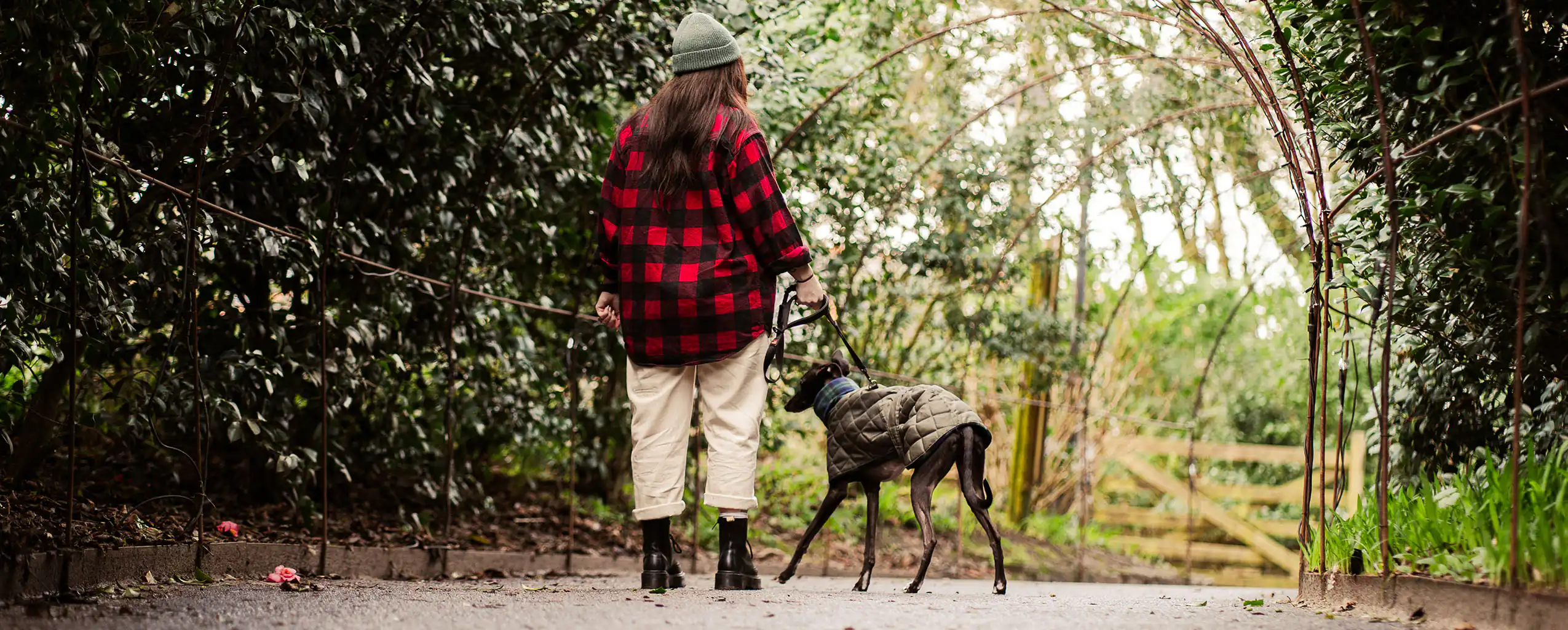 A woman walks her dog at the Lost Gardens of Heligan, Cornwall, visiting from their dog friendly cottage in Cornwall.