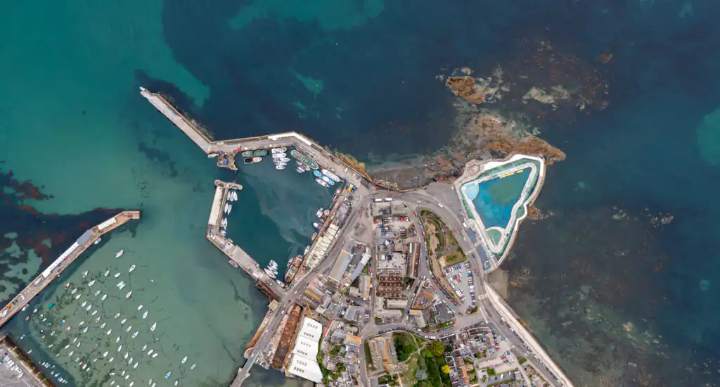 Aerial view of Penzance Jubilee Pool and surrounding area with harbour and coastline, a great place for a boat trip in Cornwall.
