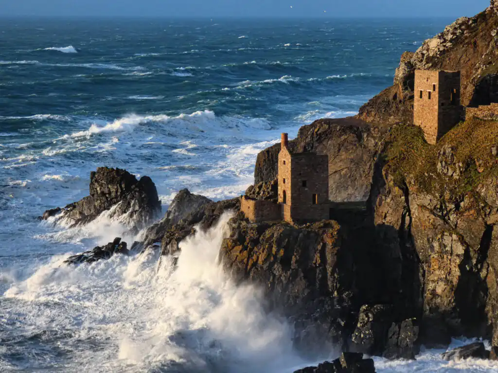 Botallack Mine perched on a cliff, overlooking the ocean, Cornwall, showcasing stunning coastal views, a great place for a guided walk with the Cornwall Geologist.