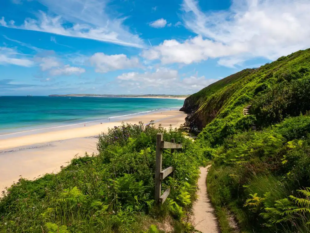 A scenic path leading to the ocean, with views of Carbis Bay Beach along the South West Coastal Path, a great walk to take in Carbis Bay.