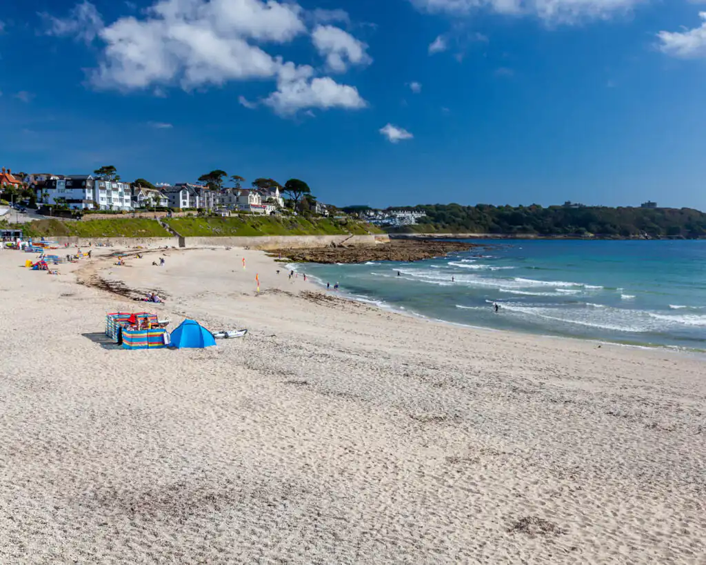 Gyllyngvase Beach in Falmouth, with clear sands and lapping waves, a place for Christmas and New Year Sea Swims in Cornwall.