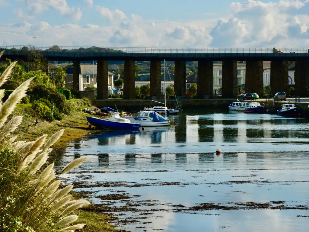 Hayle Railway Bridge spans over Hayle and its harbour, showcasing its elegant structure against a serene backdrop.