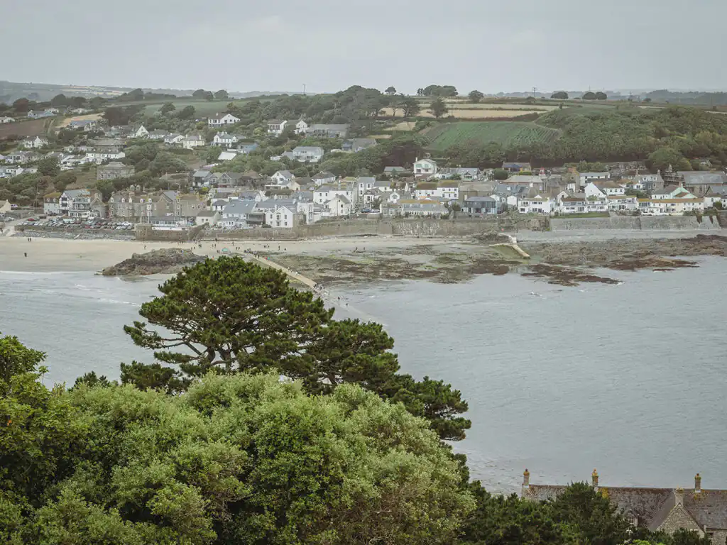 Scenic view of Marazion Town and beach from St Michael's Mount, showcasing the coastal landscape, vibrant community and its art and heritage.