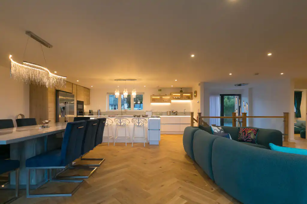 Stylish kitchen and dining area featuring blue sofas, highlighting the cosy living space of Mor Glas in Carbis Bay.
