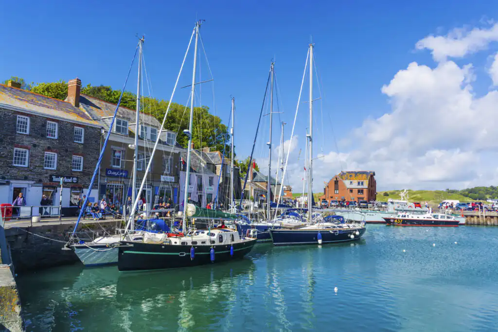 A bright blue sky dotted with fluffy white clouds over Padstow Harbour, a great thing to do in Padstow.