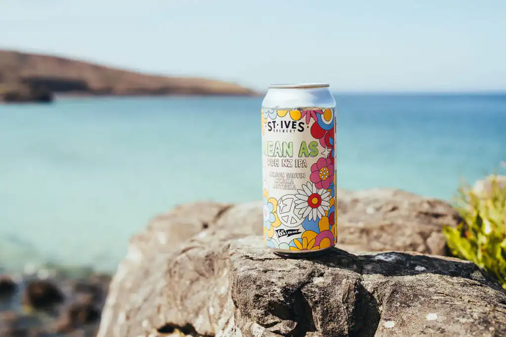 A can of beer on a rock by Porthmeor Beach, showcasing the scenic beauty of Cornwall and St Ives Brewery's offerings.
