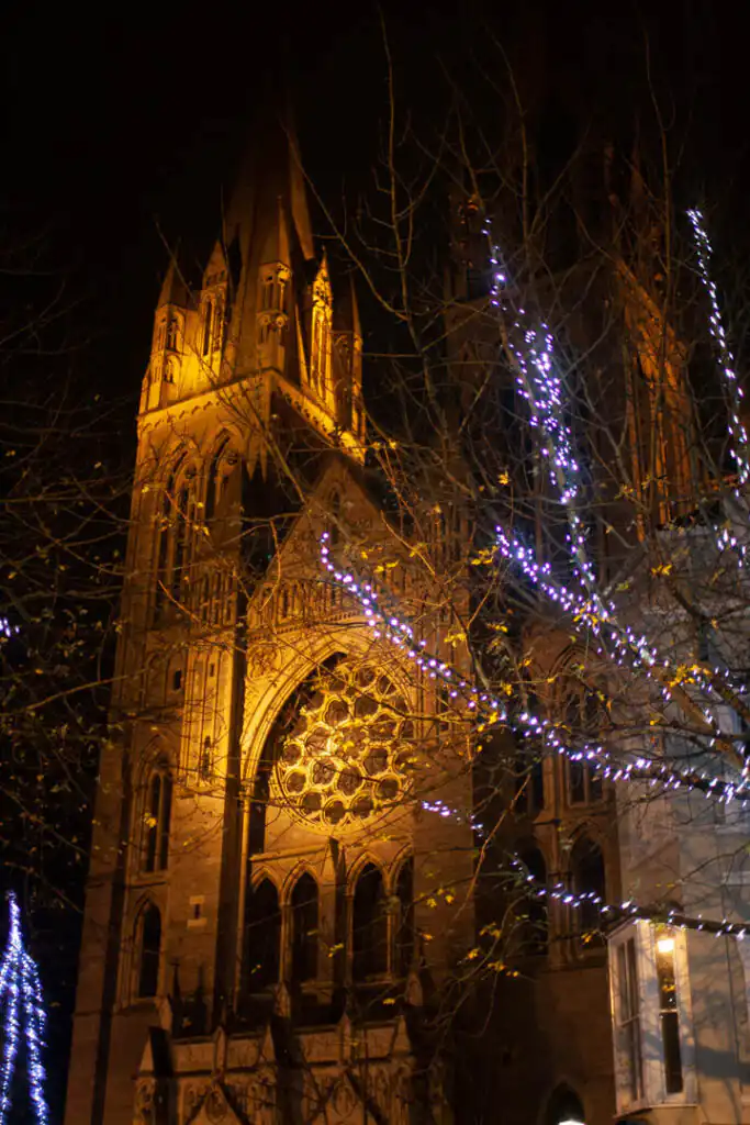 Truro Cathedral adorned for Christmas in Cornwall, featuring a prominent clock tower against a festive backdrop
