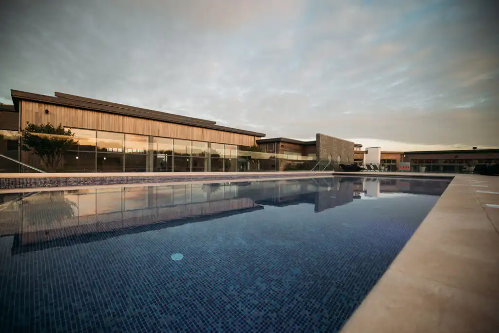 The serene Una Lido in Carbis Bay with an overcast sky at dusk, one of the best spas in Cornwall
