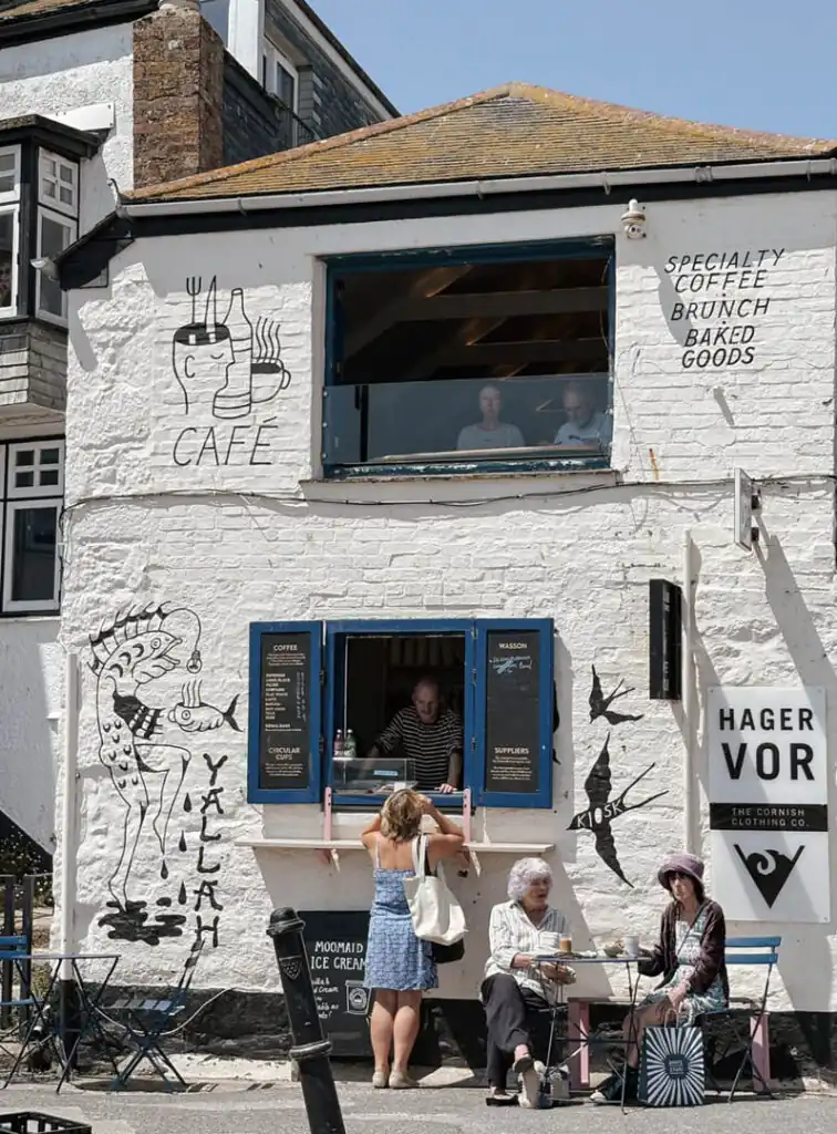 People enjoying coffee outside Yallah Cafe in St Ives, an independent shop in St Ives.