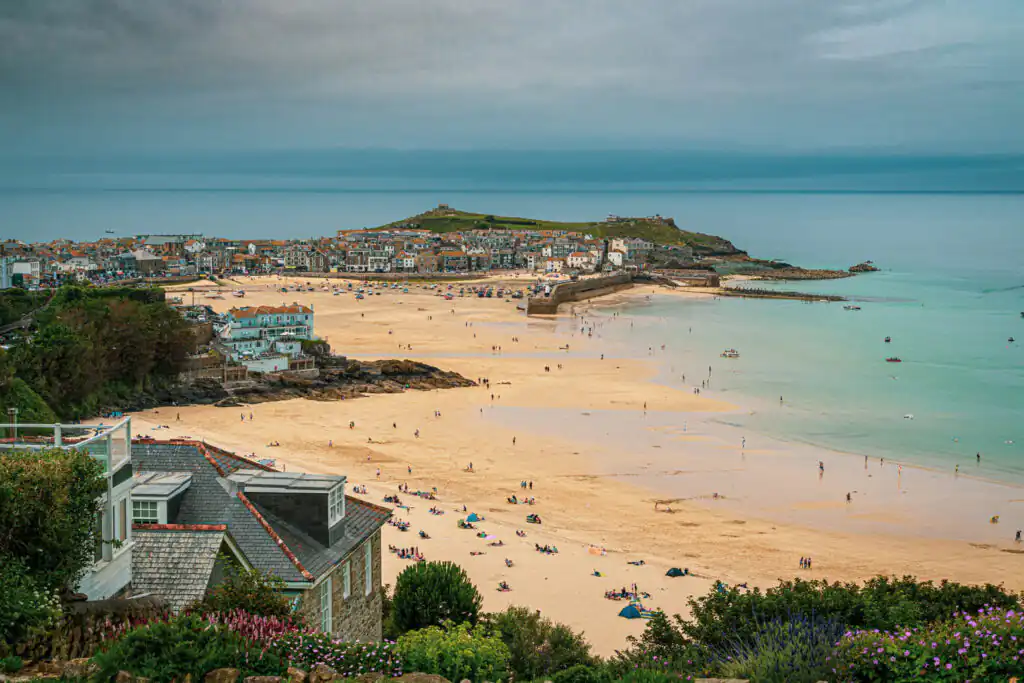A crowded Portyminster beach in St Ives Bay, Cornwall, filled with people, also home to Christmas and New Year Sea Swims.