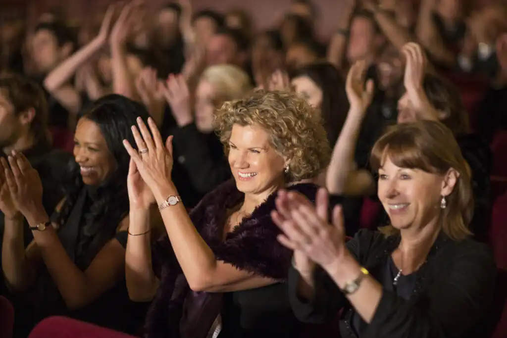 A lively audience clapping enthusiastically at the Hall for Cornwall in Truro, celebrating a performance at one of the best theatres in Cornwall.