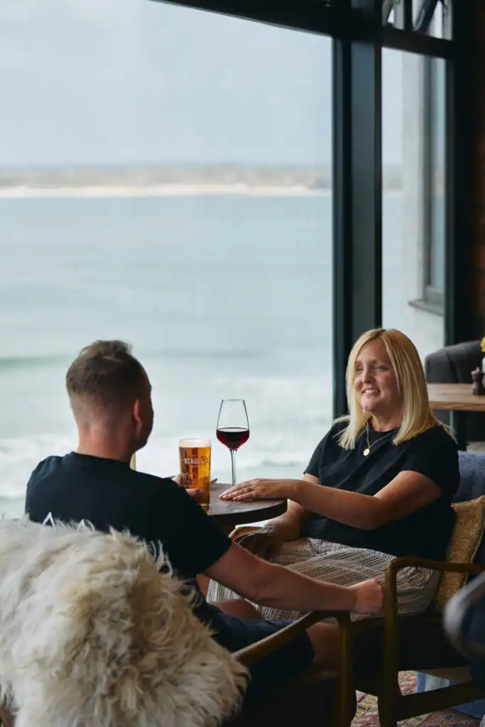 People drinking at the Pedn Olva in St Ives, with views over the harbour, a great place to visit during the winter in St Ives.