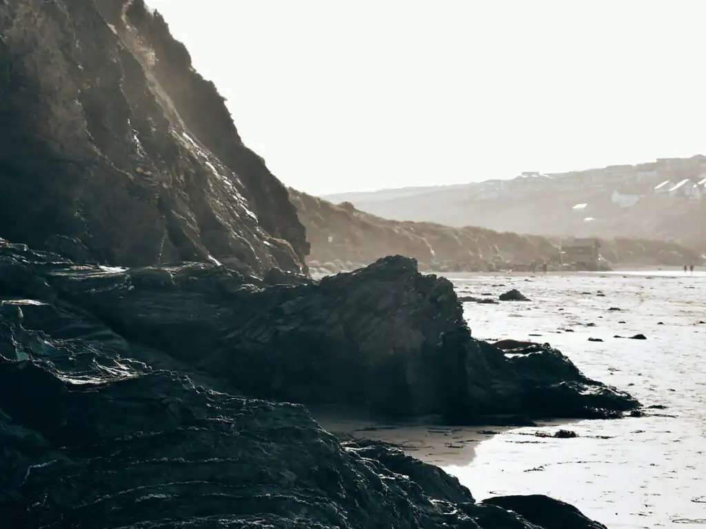 Beautiful rock formations and the ocean waves at Mawgan Porth Beach.