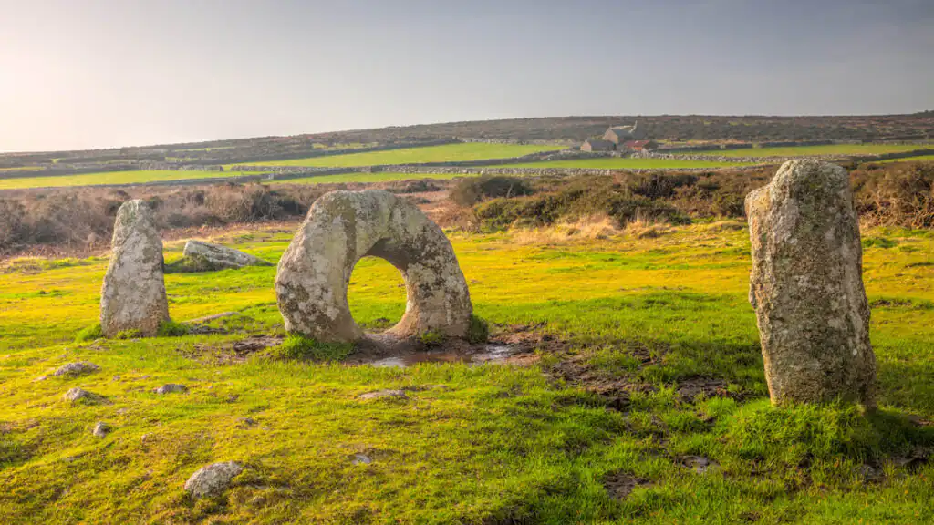 The Men an Tol stones in Cornwall, featuring iconic stone circles set against a vibrant summer landscape, a great thing to do in Summer in Cornwall.