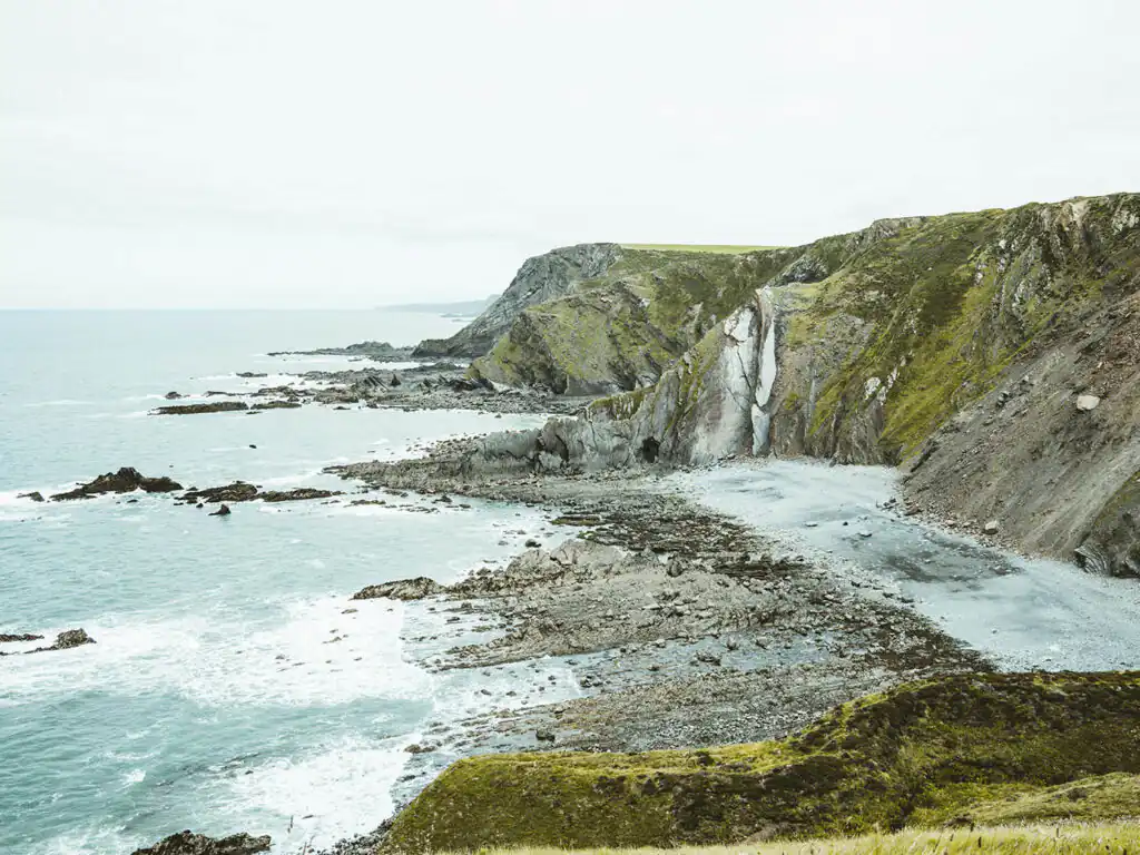 Scenic view of the ocean and cliffs from a hilltop at Morwenstow Beach, near Bude, Cornwall, a great place to visit from a Cornwall holiday cottage.