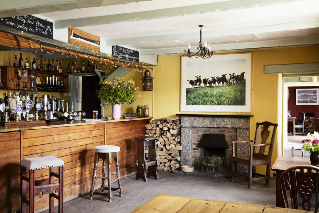 Inviting bar area with a fireplace at Gurnard's Head Pub, a great thing to do in Summer in Cornwall.