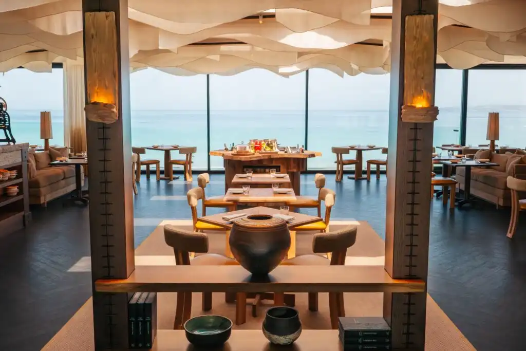 Ocean-view dining at 'Mor' restaurant in Carbis Bay, featuring tables and chairs set for a relaxing meal by the sea, a great idea when planning a holiday in Carbis Bay.